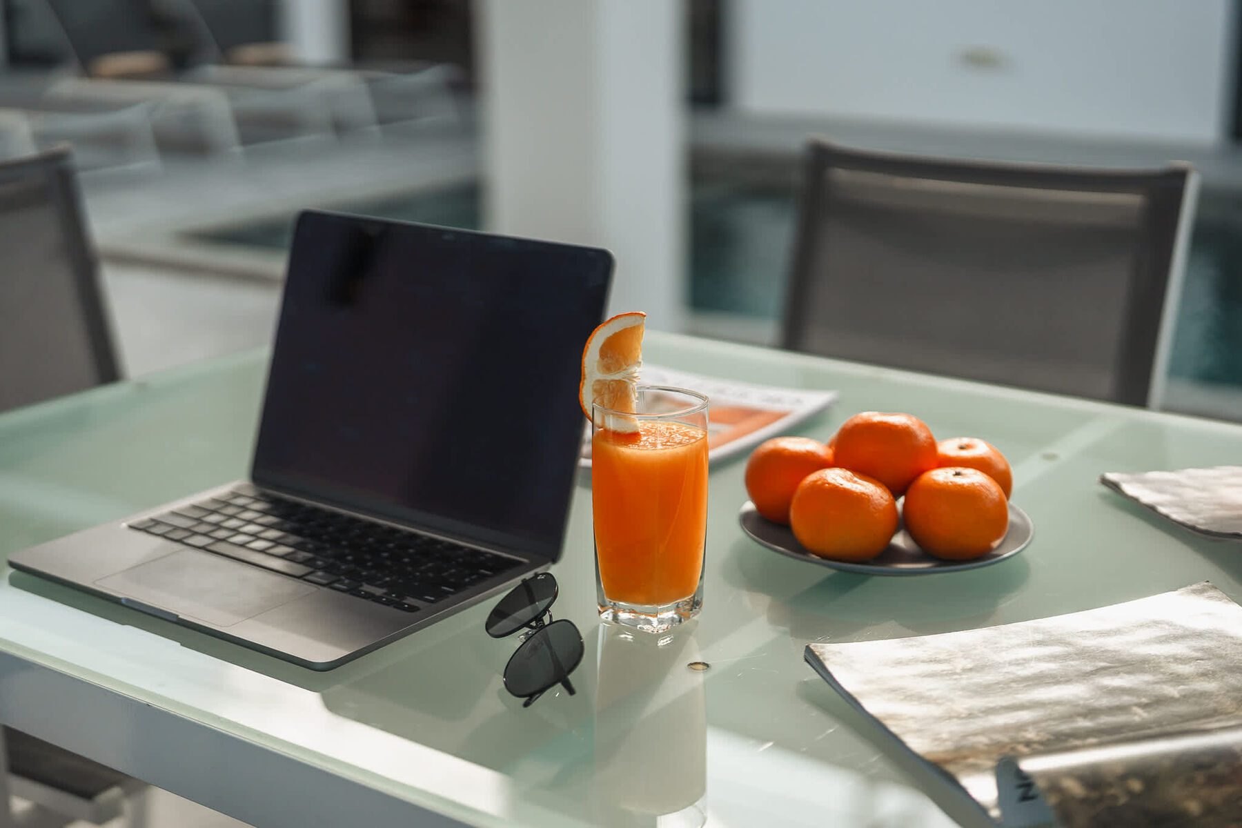 Fresh juice and fruit on a terrace table