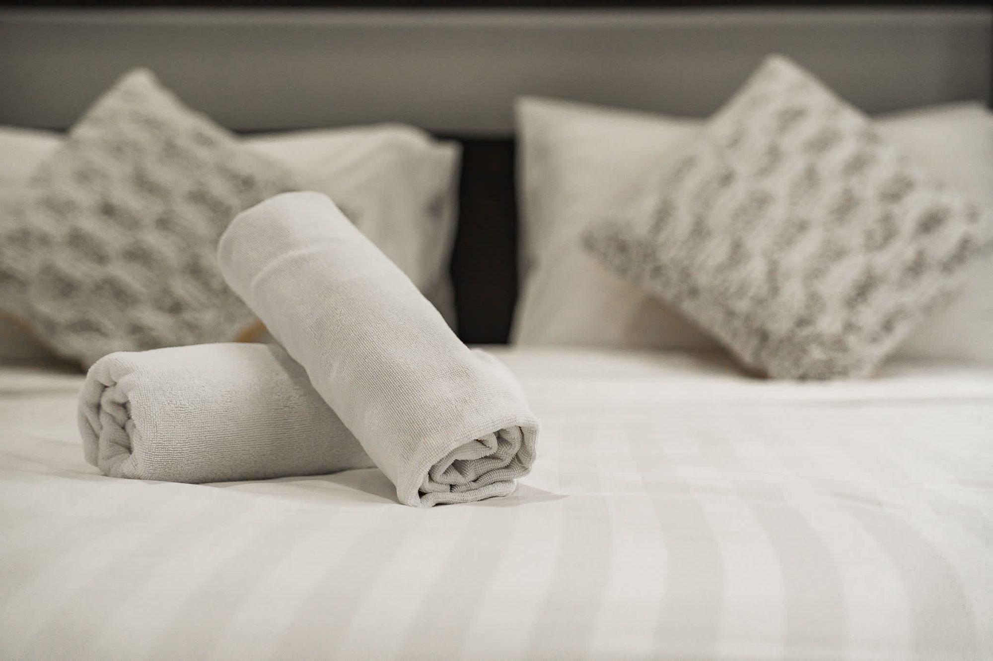 Fresh towels laid out on a bed at Villa Gina