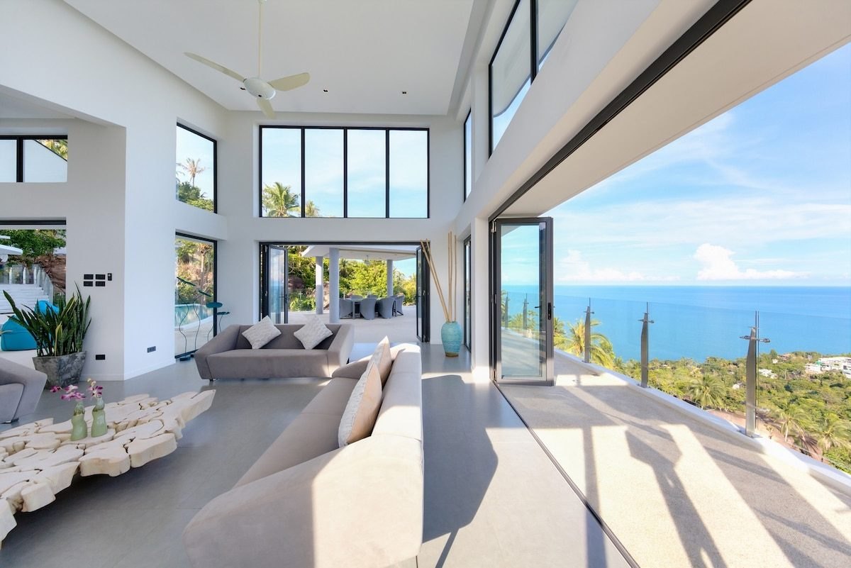 Double-height living room at Villa Maeva, open to the terrace and the sea