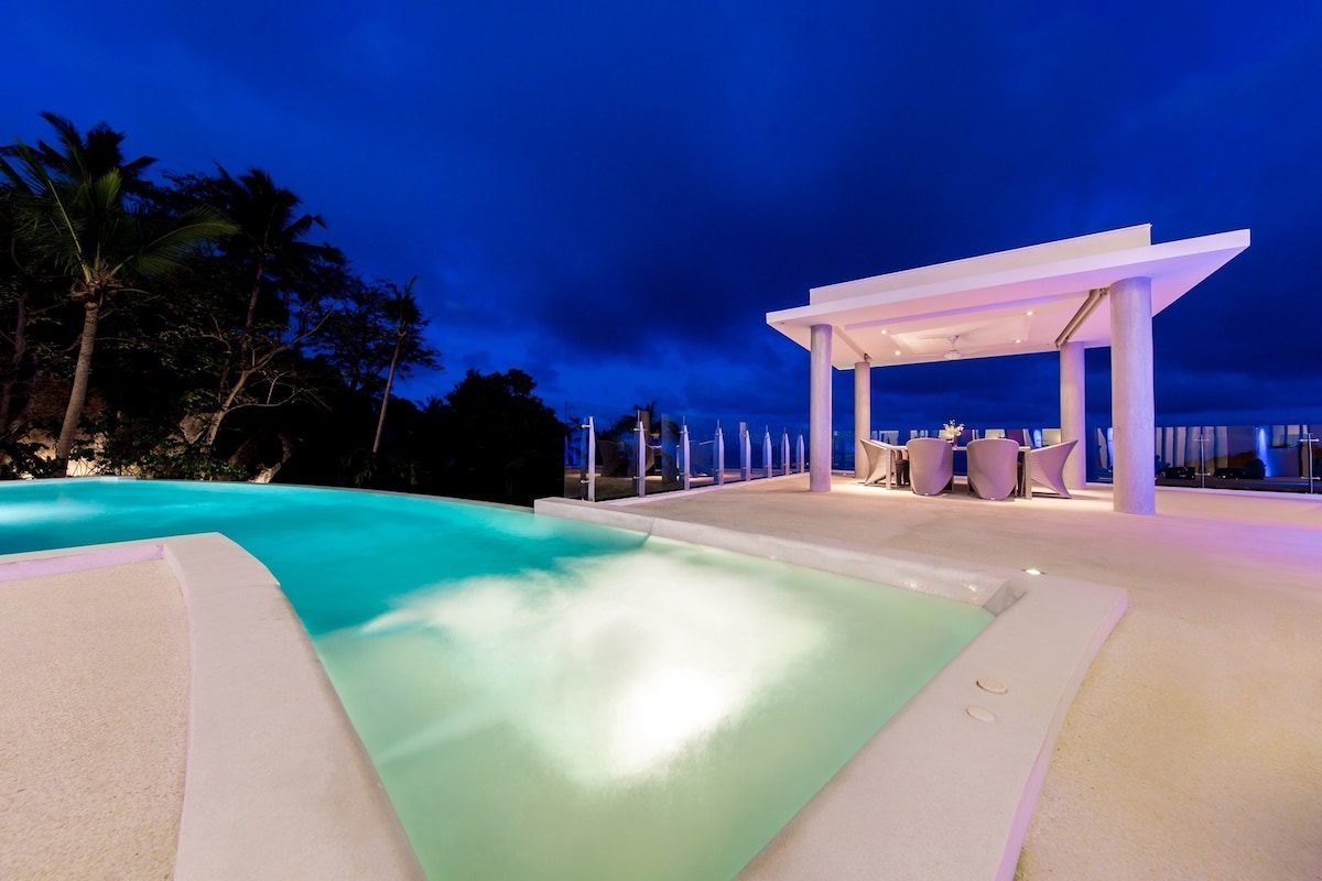 Villa Maeva's pool and dining pavilion at dusk